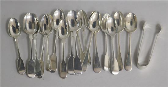 Seventeen assorted silver teaspoons, including a set of six and a pair of silver of silver sugar tongs. 11.5 oz.
